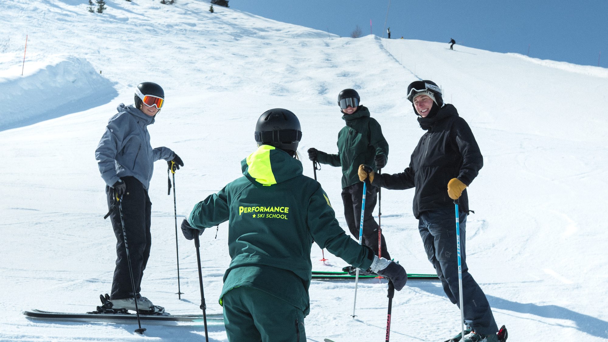 An instructor in Performance green talking a group through the next run